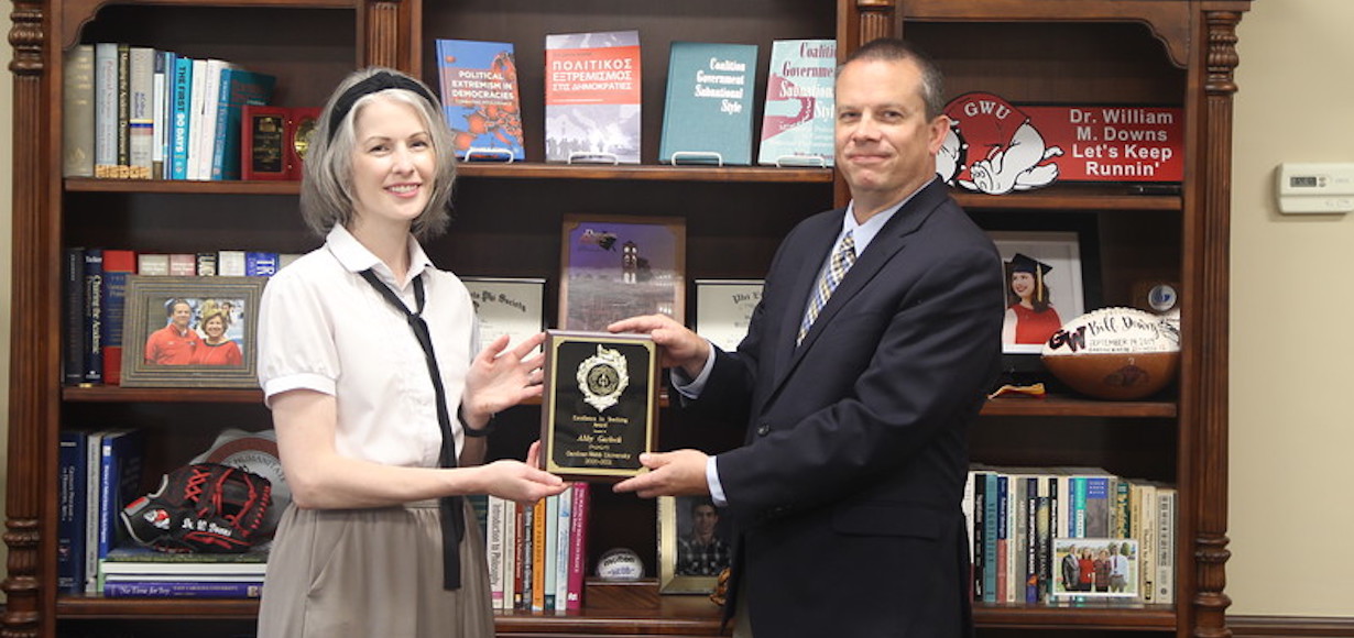 Dr. Abby Garlock receives the award from Dr. William Downs