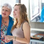 Susan Bell, left, works with a student in art class