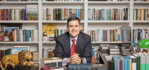 russell moore sitting at a desk in front of shelves of books