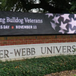 a photo of the gwu digital sign in front of webb hall
