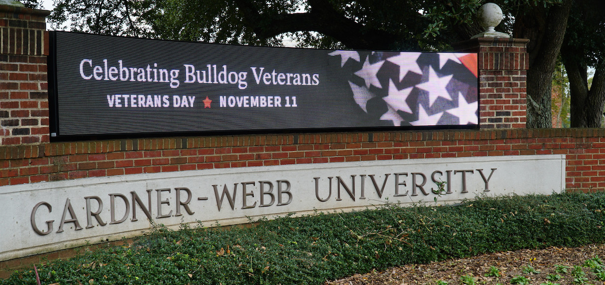 a photo of the gwu digital sign in front of webb hall