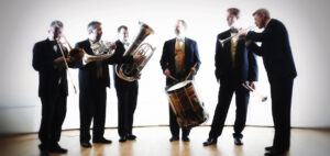 The six members of Carolina Brass pose with the instruments