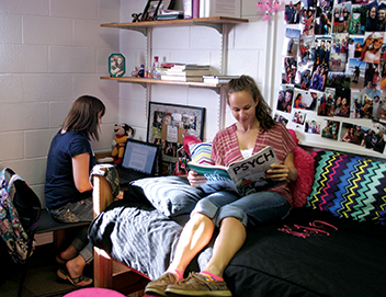 Two female students hanging out in dorm Myers Hall dorm room