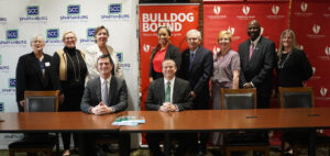 Ten officials from Gardner-Webb pose after the presidents of Spartanburg Community and Gardner-Webb sign articulation agreements.