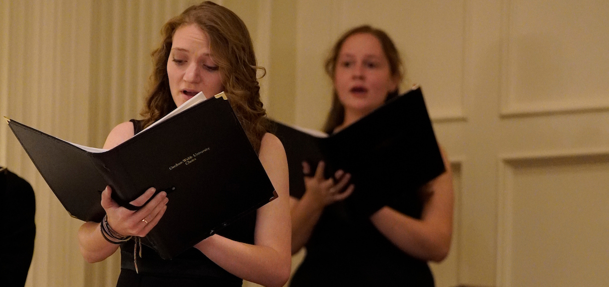 Two members of the concert choir sing in a performance last year in Dover Chapel.