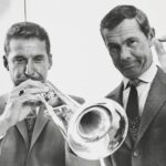 A black and white photo of Doc Severinsen, left, and Johnny Carson