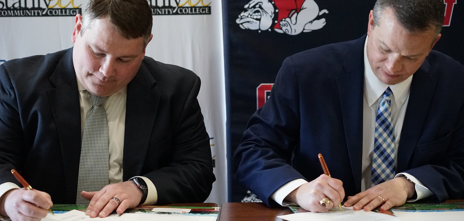 Dr. Downs and John Enamait signing agreement