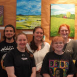 Students who will have items for sale in the art show pose for a picture