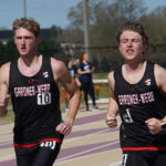 Cole Ray, no. 4, runs in a race at Winthrop University. A Gardner-Webb teammate is on the right and another competitor is on his left.