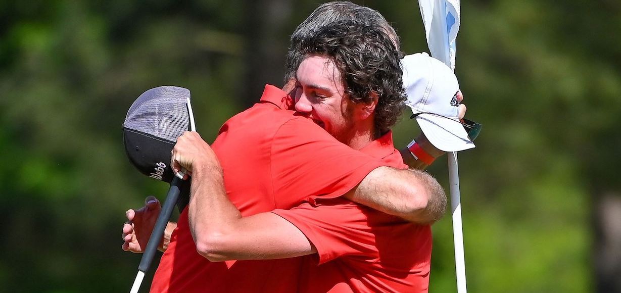 Zack Byers receives a congratulatory hug from Coach Tee Burton