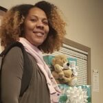 Alexandra Arrington poses with diapers and wipes at GWU's charlotte campus.