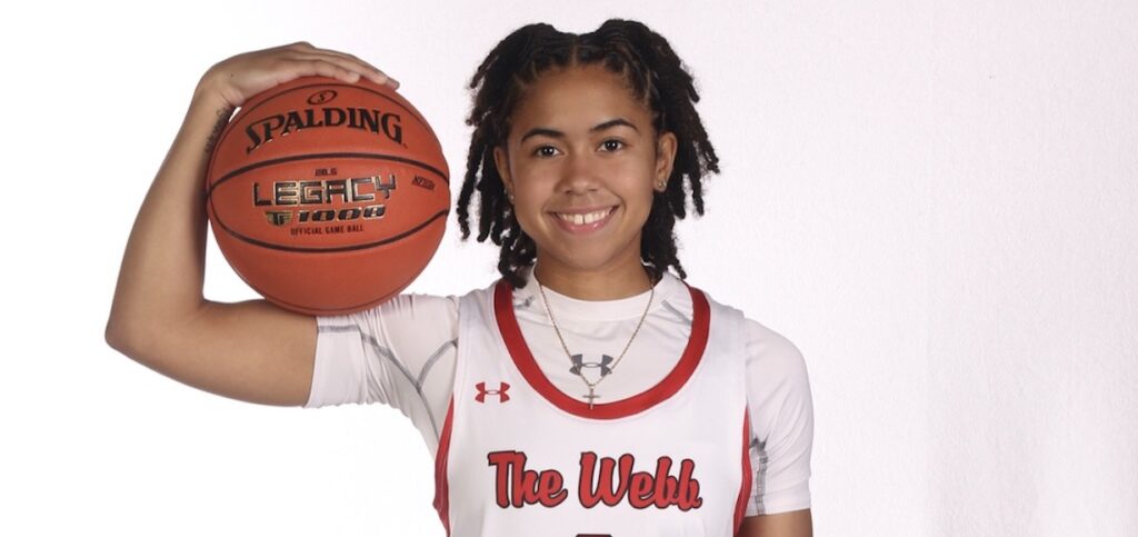 L'Mia Littlejohn in a basketball uniform, holding a basketball