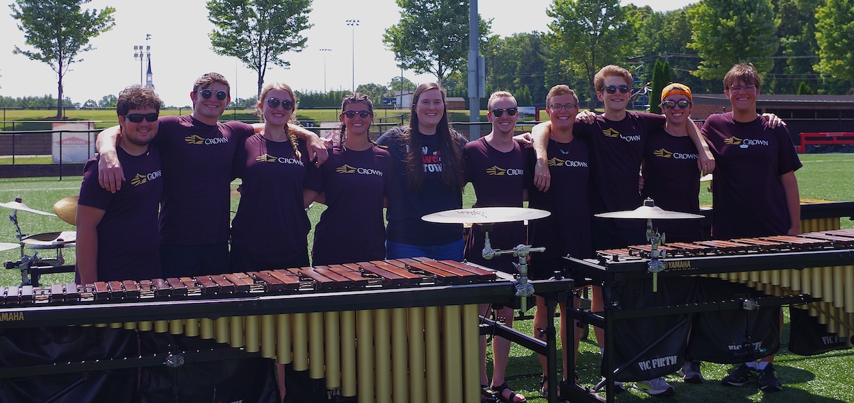 Dr. Sarah Fabian, center, visits with members of Carolina Crown as they practice on the Gardner-Webb campus.