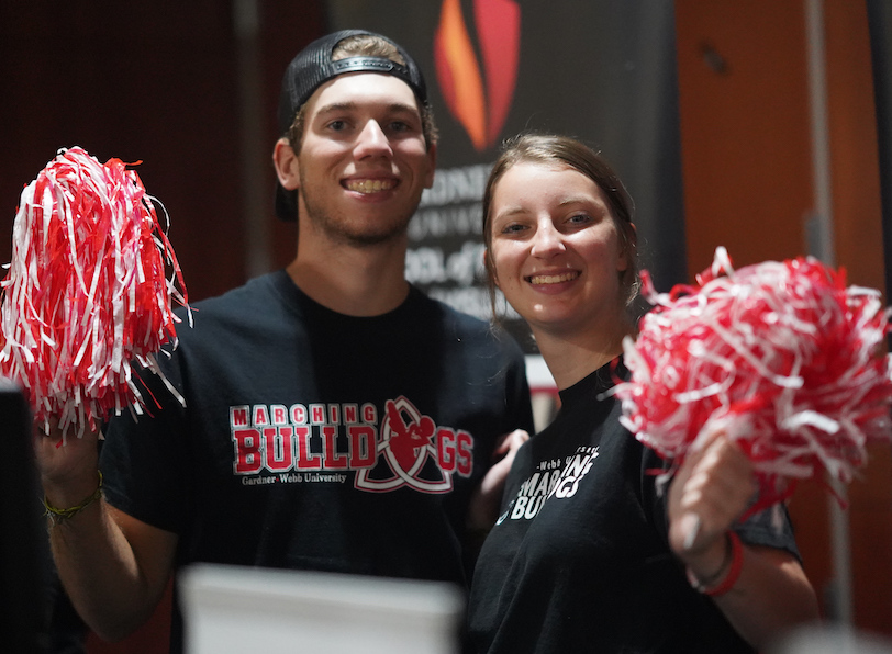 Two members of the Marching Bulldogs hold pom-poms.