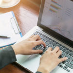 person using microsoft excel on laptop