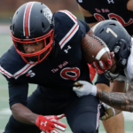 a gwu player gets away from a tackle