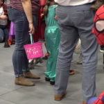 A youngster in a Spiderman costume sees an older person in a Spidey costume.P