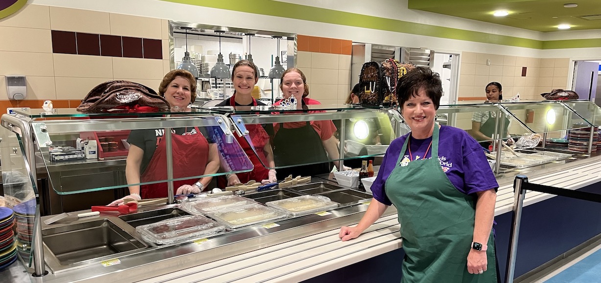 A group from GWU serves in the cafeteria at Give Kids The World Village.