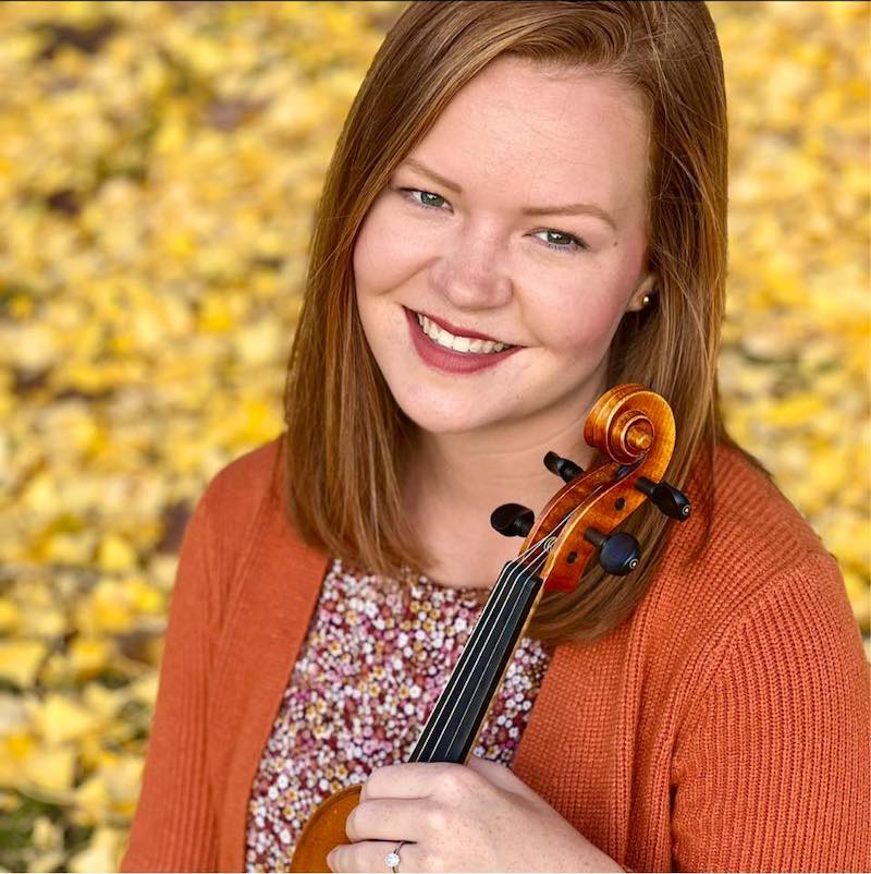 A photo of Hannah Thurman holding her violin