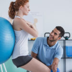 physical therapist working with patient