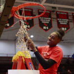 Jhessyka Williams cuts down the net in celebration of winning the Big South Conference Season Championship.
