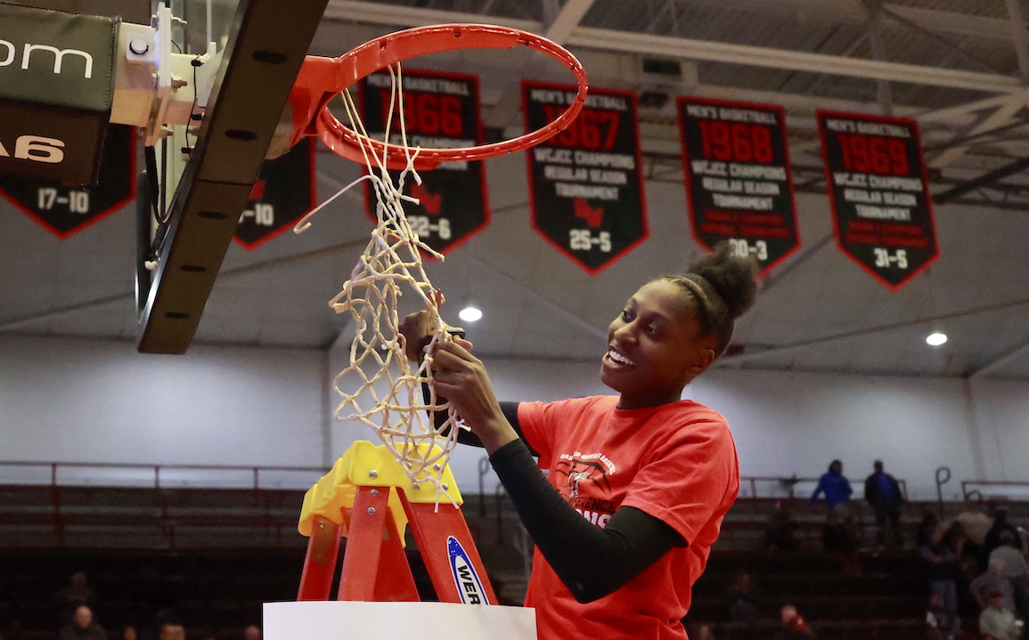 Jhessyka Williams cuts down the net in celebration of winning the Big South Conference Season Championship.