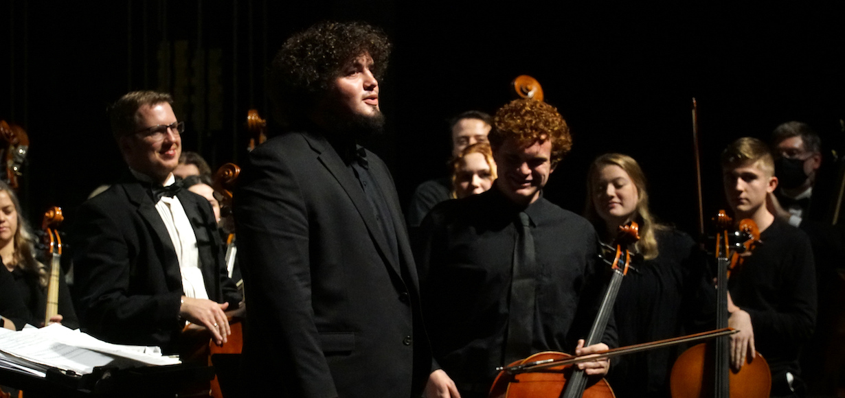 Caleb Etchison and others on stage during an orchestra concert