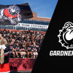 banner with cheerleader waving bulldog flag in front of crowd