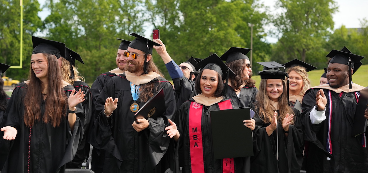 graduates celebrate receiving their degrees