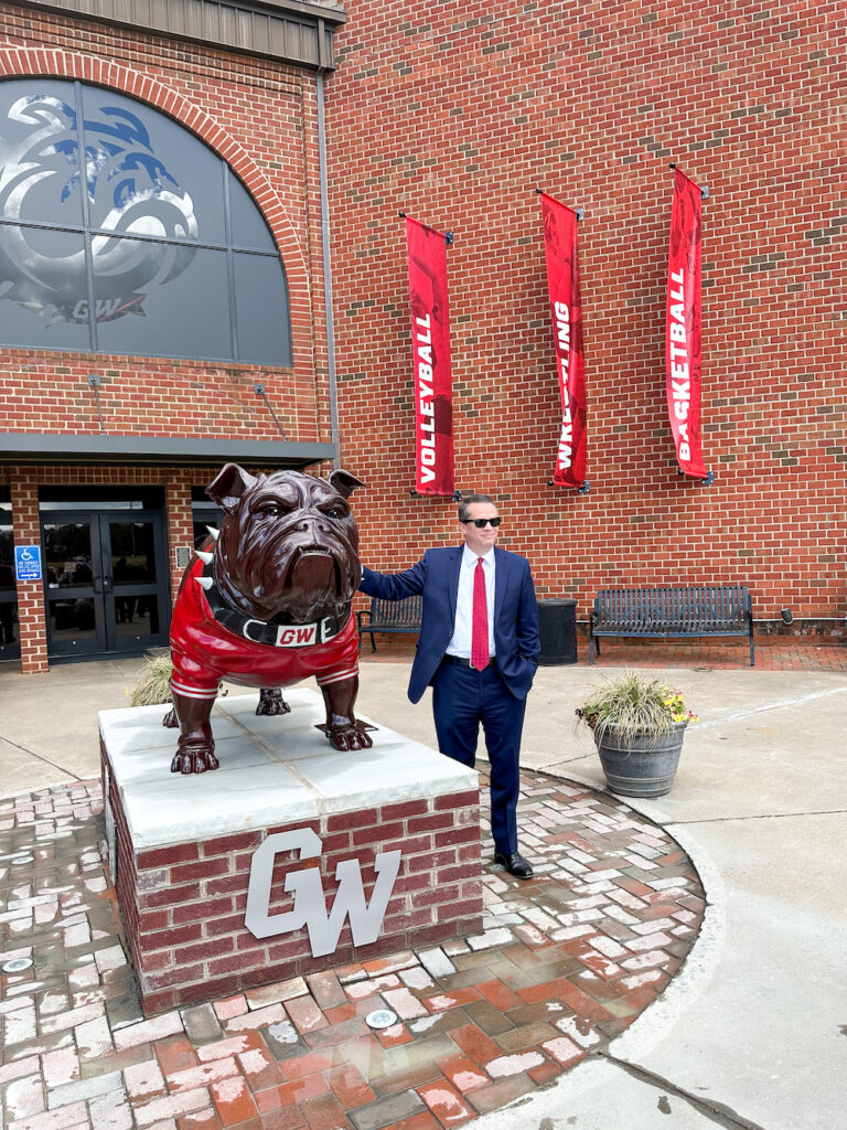 Dr. Downs poses with new bulldog statue