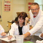 Dr. Jay Zimmer, left, helps students with an activity