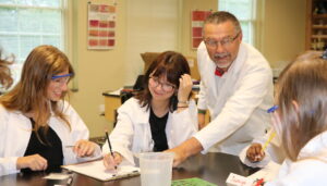 Dr. Jay Zimmer, left, helps students with an activity