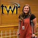 Emily White poses inside the offices of Trans World Radio