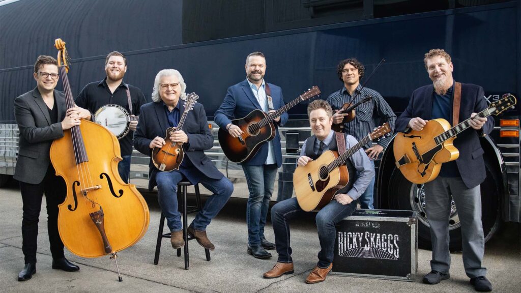 Ricky Scaggs and the Kentucky Thunder pose with instruments in front of tour bus