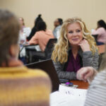 Dr. Yvonne Smith listens to two students in a roundtable discussion.