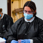 A volunteer at the Remote Area Medical Clinic works to sterilize dental tools.