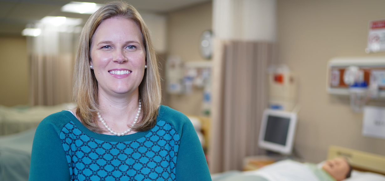 Tracy Arnold stands in a simulation lab