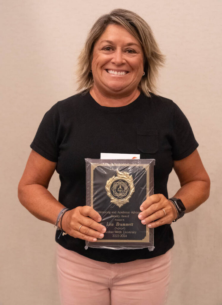 Lisa Brummett holds her award