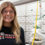 Kyndal Jackson in front of a steam distiller in GWU's science lab
