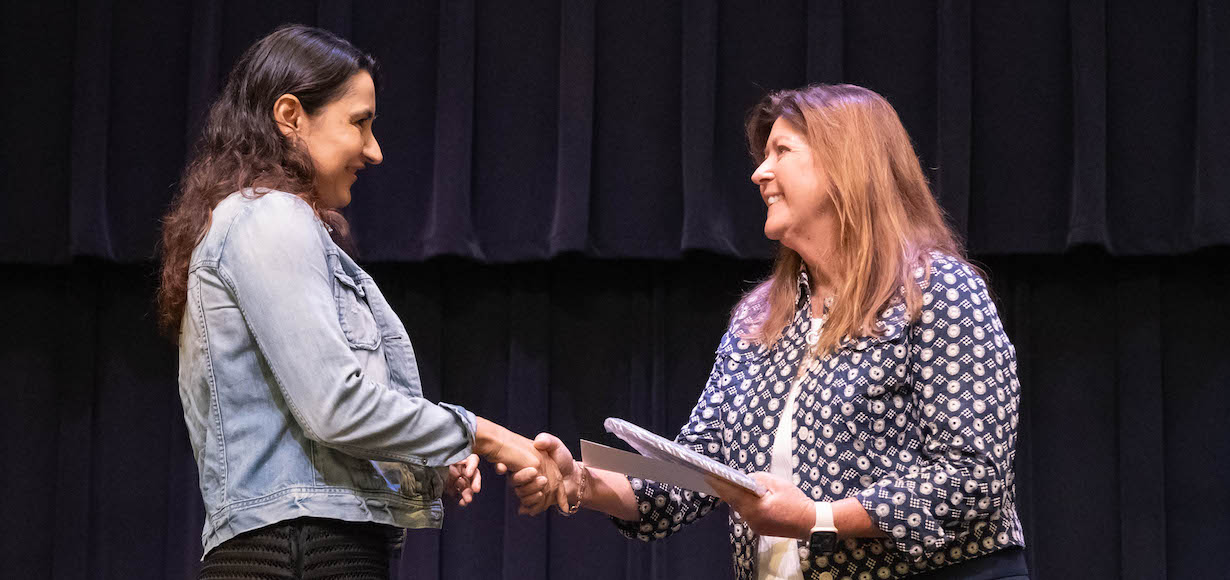 Dr. Iva Naydenova accepts the Excellence in Teaching Award from Provost and Vice President for Academic Affairs. Dr. Karen Aubrey