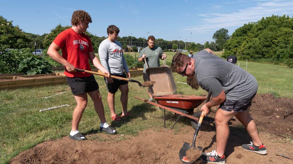 GW football players volunteer at community garden