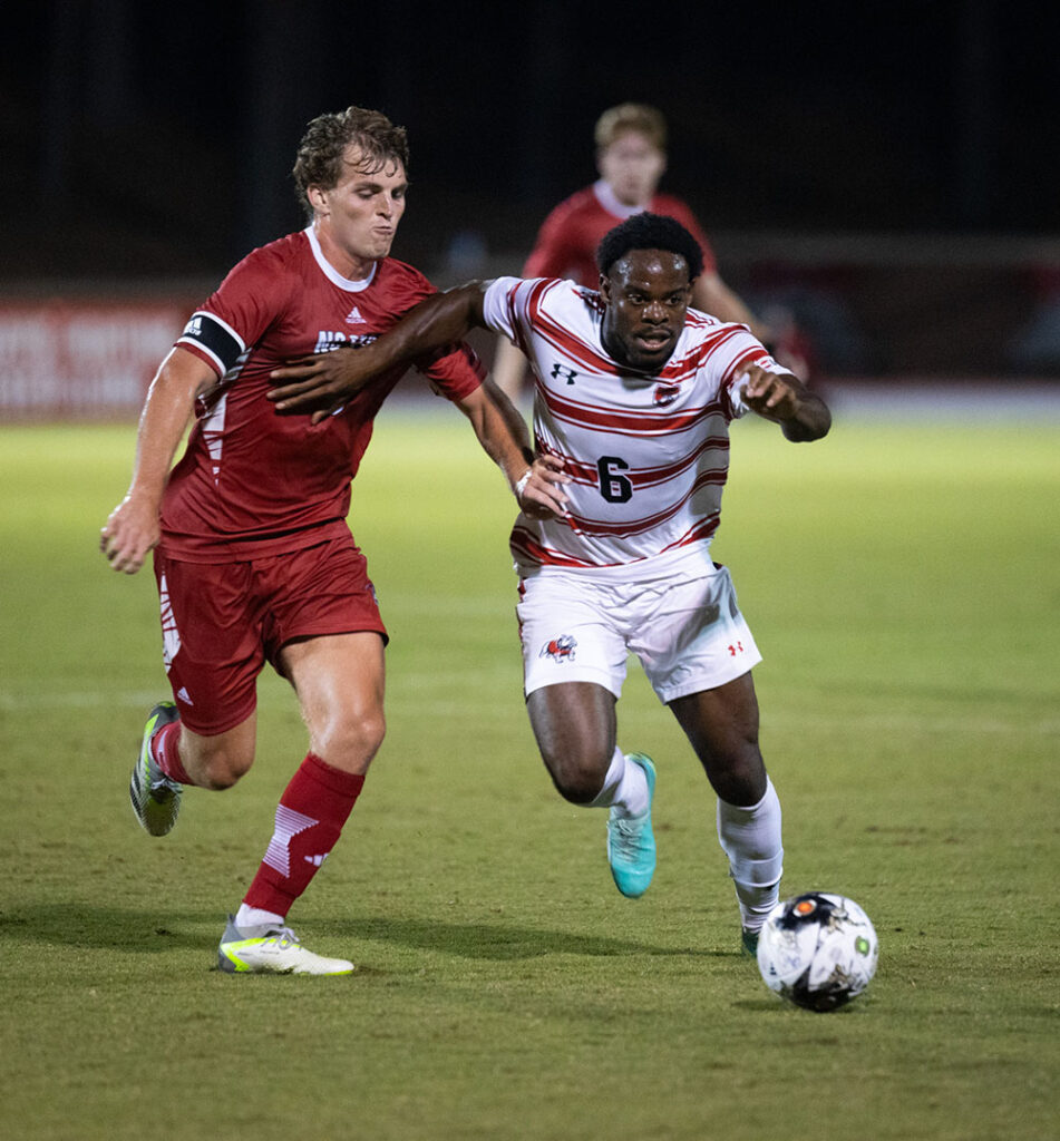Gwu Men's Soccer kicking ball away from opponent