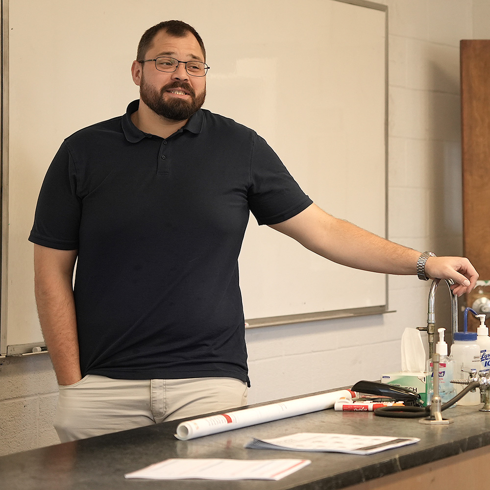 GWU Professor Hawkins standing in front of laboratory classroom