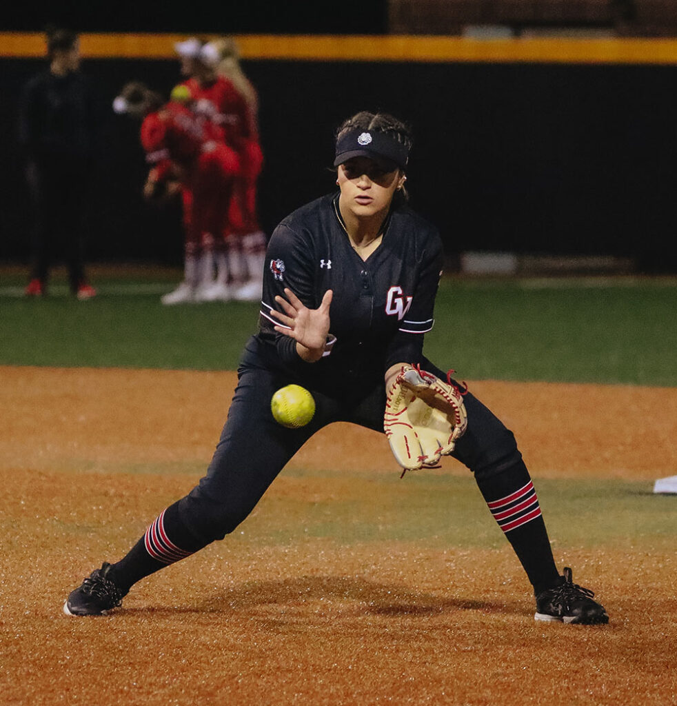 GWU Softball player catching ball