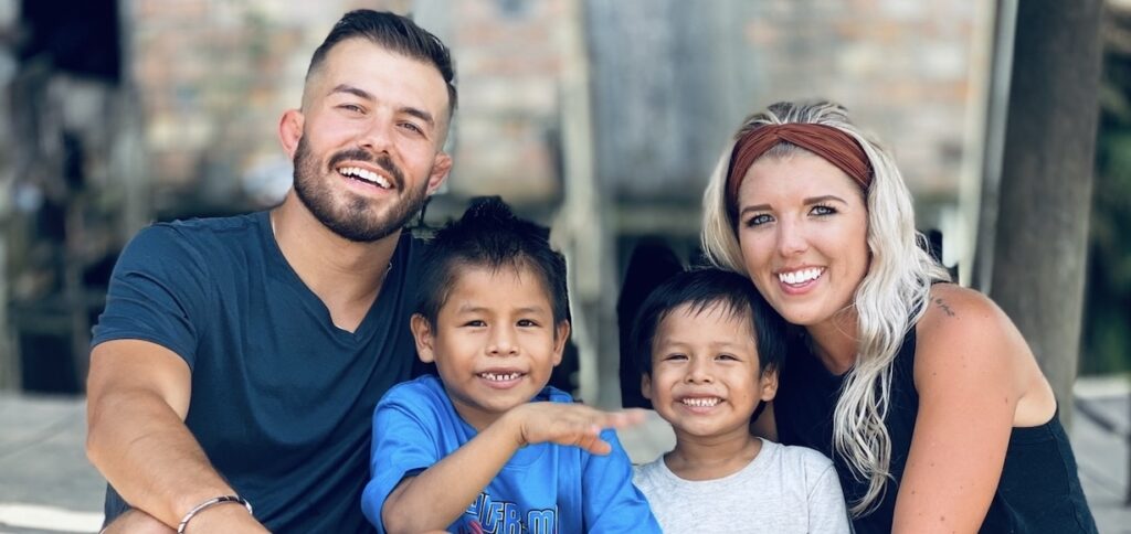 Nick and Caroline Leitten pose with two of the children in their care.