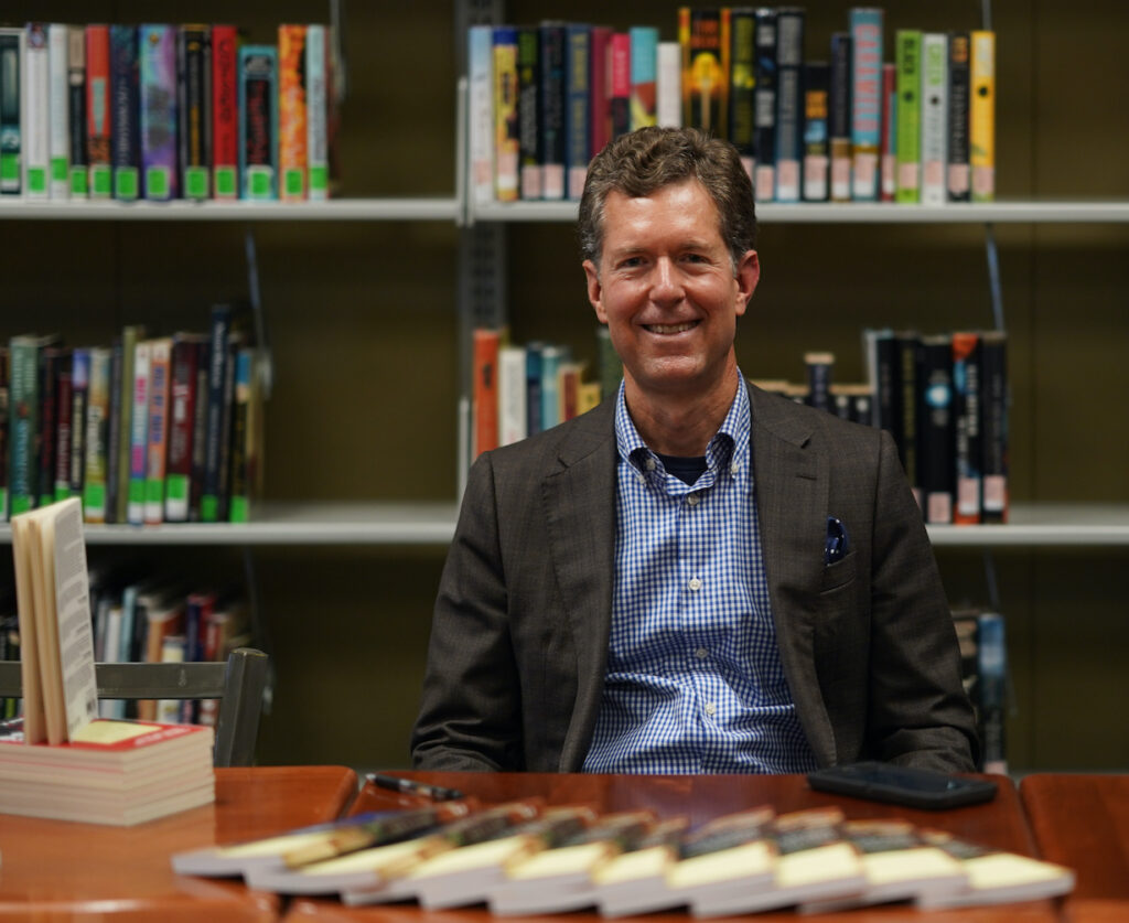 Steve Harmon poses with books