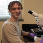 McCoy Stowe with a microscope