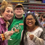 three GWU students pose at Octoberfest
