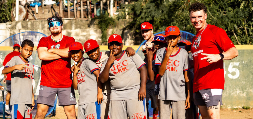 members of the baseball team with children in Dominican Republic