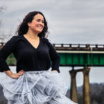 Gaby Laurent poses in front of a bridge